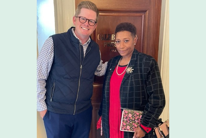 woman in blazer and man in jacket smiling